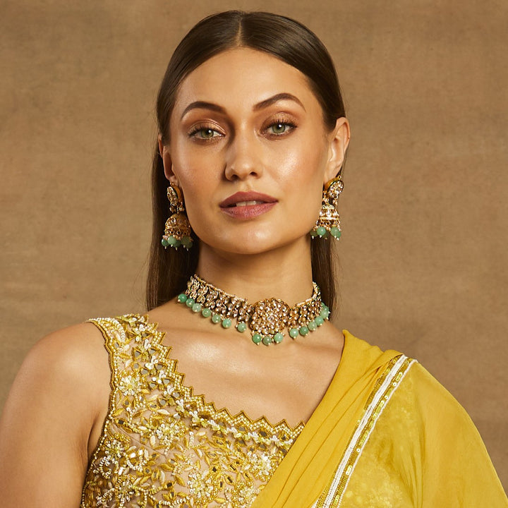 women wearing Sea Green Polki Choker Set along with yellow saree